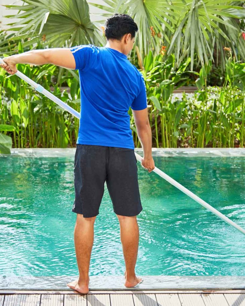 young-man-cleaning-pool-e1628821970333.jpg